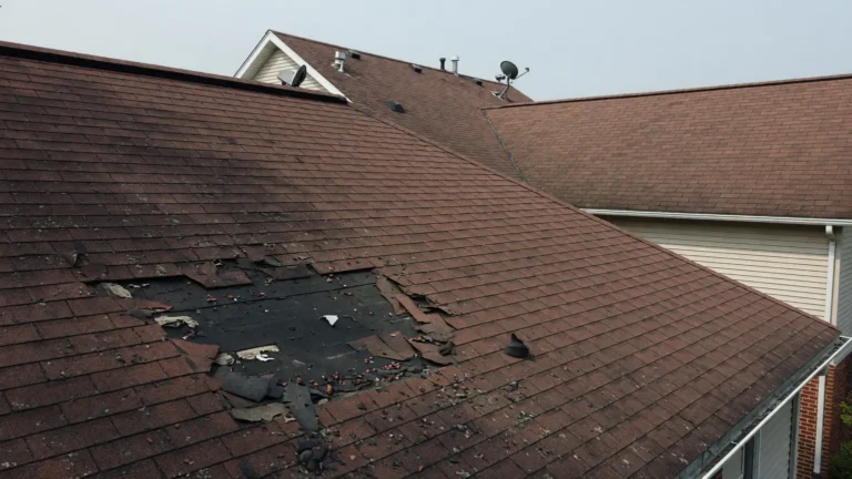 Asphalt shingle roof with localized damage illustrating repair vs replacement